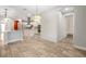 Open-concept dining area next to the kitchen with a modern light fixture at 3844 Bowfin Trl, Kissimmee, FL 34746