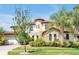 Beautiful two-story home with a turret, tile roof, stone accents and manicured landscaping at 3844 Bowfin Trl, Kissimmee, FL 34746