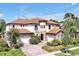 Stunning mediterranean home with red tile roof, turret and manicured lawn at 3844 Bowfin Trl, Kissimmee, FL 34746