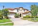 Elegant home featuring a three-car garage, brick-paved driveway, and well-maintained lawn at 3844 Bowfin Trl, Kissimmee, FL 34746
