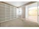 A flex room or office with built-in shelving, carpet, and a window for natural light at 3844 Bowfin Trl, Kissimmee, FL 34746