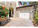 Close-up of garage and front entry, showcasing stone accents and a brick paver driveway at 3844 Bowfin Trl, Kissimmee, FL 34746