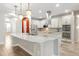 Modern kitchen features a marble island, stainless appliances, and a sleek range hood at 3844 Bowfin Trl, Kissimmee, FL 34746