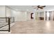 Spacious living room featuring tile floors, modern ceiling fan, and a convenient wet bar area at 3844 Bowfin Trl, Kissimmee, FL 34746