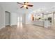 Open living space featuring modern lighting, tile floors, and an archway leading into the kitchen at 3844 Bowfin Trl, Kissimmee, FL 34746
