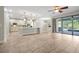 Open floor plan with modern kitchen, living space and sliding glass doors to the outdoor pool area at 3844 Bowfin Trl, Kissimmee, FL 34746