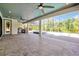 Expansive covered patio with outdoor kitchen, pool, and lush landscaping at 3844 Bowfin Trl, Kissimmee, FL 34746