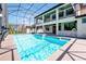 Screened-in pool and hot tub with exterior kitchen and second story balcony offer luxury outdoor living at 3844 Bowfin Trl, Kissimmee, FL 34746