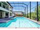 Relax in this screened-in pool and hot tub with outdoor kitchen and lush backyard at 3844 Bowfin Trl, Kissimmee, FL 34746