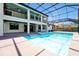 Enjoy the screened-in pool and hot tub with a covered patio and outdoor kitchen at 3844 Bowfin Trl, Kissimmee, FL 34746