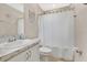 Clean bathroom with marble countertop, a toilet, and a shower curtain at 4270 Swan St, Haines City, FL 33844