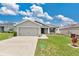 Charming single-story home featuring a well-maintained lawn, a two-car garage and beautiful landscaping at 4270 Swan St, Haines City, FL 33844
