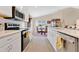 Eat-in kitchen featuring modern appliances, white cabinets, and a dining area with views at 4270 Swan St, Haines City, FL 33844