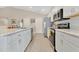 Bright kitchen featuring stainless steel appliances, white cabinetry, and a stylish countertop at 4270 Swan St, Haines City, FL 33844