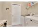 Convenient laundry area featuring modern washer and dryer, plus a door at 4270 Swan St, Haines City, FL 33844