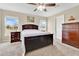 Cozy main bedroom features a dark wood bed frame, plush carpet, and natural lighting at 4270 Swan St, Haines City, FL 33844