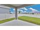 Covered patio overlooking the backyard with a white vinyl fence and freshly cut grass at 4270 Swan St, Haines City, FL 33844