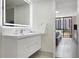 Bright bathroom featuring white vanity with illuminated mirror, offering modern style and comfort at 530 E Central Blvd # 803, Orlando, FL 32801