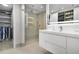 Bright bathroom features a glass walk-in shower, walk-in closet, and illuminated vanity mirror at 530 E Central Blvd # 803, Orlando, FL 32801