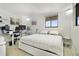 Bright bedroom featuring white and blue bedding, desk, and window with natural light at 530 E Central Blvd # 803, Orlando, FL 32801