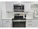 Modern kitchen featuring stainless steel appliances and sleek white cabinetry at 530 E Central Blvd # 803, Orlando, FL 32801