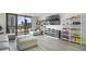 Bright and airy living room with white couches, shelves, and city views at 530 E Central Blvd # 803, Orlando, FL 32801