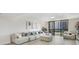 Bright and airy living room with comfortable white couches and balcony access at 530 E Central Blvd # 803, Orlando, FL 32801