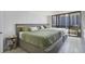 Spacious main bedroom features two beds with green bedding and sliding glass doors to balcony at 530 E Central Blvd # 803, Orlando, FL 32801