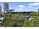 Scenic view of a lake surrounded by lush greenery and modern buildings at 530 E Central Blvd # 803, Orlando, FL 32801