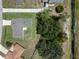 An aerial view of the home displaying the layout, landscaping, and surrounding neighborhood at 670 Cotulla Dr, Kissimmee, FL 34758