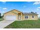 Charming single-story home featuring a two-car garage, well-manicured lawn, and inviting curb appeal at 670 Cotulla Dr, Kissimmee, FL 34758