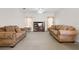 Cozy living room featuring comfortable sofas and neutral decor for relaxation and entertainment at 670 Cotulla Dr, Kissimmee, FL 34758