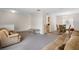 Spacious living room with neutral walls, with view into dining room at 670 Cotulla Dr, Kissimmee, FL 34758