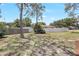 Large, grassy backyard with a privacy fence and mature trees at 6700 Tamarind Cir, Orlando, FL 32819