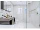 Modern bathroom showcasing marble tiling, a sleek vanity, and a glass-enclosed shower at 6700 Tamarind Cir, Orlando, FL 32819