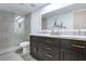 Elegant bathroom with a double vanity, marble countertop, and glass-enclosed shower at 6700 Tamarind Cir, Orlando, FL 32819