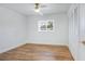 Bright bedroom featuring wood-look floors, a ceiling fan, and a window with tree views at 6700 Tamarind Cir, Orlando, FL 32819