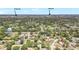 An aerial view of the vibrant community surrounded by greenery and local attractions in the distance at 6700 Tamarind Cir, Orlando, FL 32819