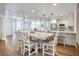 Bright dining area with white table, chairs, and modern pendant lighting open to the kitchen at 6700 Tamarind Cir, Orlando, FL 32819