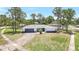 Well-manicured lawn and landscaping highlight this home's curb appeal, complete with a circular driveway at 6700 Tamarind Cir, Orlando, FL 32819