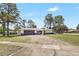 Charming single-story home with a well-maintained lawn and a long driveway leading to an attached garage at 6700 Tamarind Cir, Orlando, FL 32819