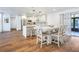 Open-concept space featuring a kitchen with white cabinets and an adjacent dining area with ample seating at 6700 Tamarind Cir, Orlando, FL 32819