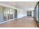 Spacious sunroom featuring tile floors and multiple sliding glass doors at 6700 Tamarind Cir, Orlando, FL 32819