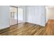 Living room with wood-look floors, sliding glass doors, and neutral walls at 6700 Tamarind Cir, Orlando, FL 32819
