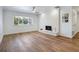 Bright living room with a white brick fireplace, neutral walls, and wood-look flooring at 6700 Tamarind Cir, Orlando, FL 32819