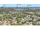 An aerial view of the surrounding neighborhood, showcasing lush green trees, local attractions, and the lake at 6700 Tamarind Cir, Orlando, FL 32819