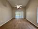 Bedroom with ceiling fan, carpet and sliding glass door at 703 Tartan Loop, Lake Wales, FL 33853