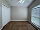 Comfortable bedroom offering a ceiling fan, carpet, and a large window at 703 Tartan Loop, Lake Wales, FL 33853
