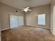 Bedroom with ceiling fan, carpet and sliding glass door at 703 Tartan Loop, Lake Wales, FL 33853