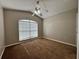 Inviting bedroom featuring a ceiling fan and window with natural light at 703 Tartan Loop, Lake Wales, FL 33853